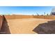 A large, undeveloped backyard features a block wall at 5344 W Manzanita Dr, Glendale, AZ 85302