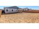 The back of the home features a covered patio and large undeveloped backyard at 5344 W Manzanita Dr, Glendale, AZ 85302