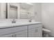 A bathroom with a double sink vanity, white countertops, and a large mirror at 5344 W Manzanita Dr, Glendale, AZ 85302