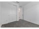 Bedroom featuring plush gray carpeting, a closet, and an open doorway with lots of light at 5344 W Manzanita Dr, Glendale, AZ 85302