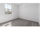 Bright bedroom featuring plush gray carpeting and ample natural light through windows at 5344 W Manzanita Dr, Glendale, AZ 85302