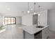 Open-concept kitchen with a center island, white cabinets, view to a great room with sliding glass doors at 5344 W Manzanita Dr, Glendale, AZ 85302
