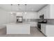 Spacious kitchen with white cabinets, a large island, stainless steel appliances and modern pendant lights at 5344 W Manzanita Dr, Glendale, AZ 85302