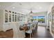 Formal dining room with a long wooden table and white upholstered chairs at 5518 E Sanna St, Paradise Valley, AZ 85253