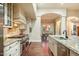 Modern kitchen with stainless steel appliances, granite countertops, white cabinetry, and hardwood flooring at 10050 N 58Th Pl, Paradise Valley, AZ 85253