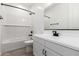 This bathroom features a white tub and vanity with black accents at 5332 W Manzanita Dr, Glendale, AZ 85302
