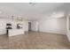 Open concept kitchen and living area with white cabinets and tile flooring throughout at 5332 W Manzanita Dr, Glendale, AZ 85302