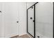 A close up view of an enclosed shower stall with black trim and hardware, and tile surround at 5332 W Manzanita Dr, Glendale, AZ 85302
