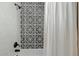 Updated bathroom with patterned tile and shower/tub combo at 934 E 8Th St, Mesa, AZ 85203