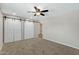 Bedroom with carpet, barn doors to closet, and ceiling fan at 934 E 8Th St, Mesa, AZ 85203