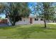 Ranch style home with a landscaped lawn, updated facade, and a large driveway at 934 E 8Th St, Mesa, AZ 85203