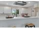 Modern kitchen features white shaker cabinets, quartz countertops, and a stainless steel range hood at 934 E 8Th St, Mesa, AZ 85203