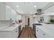 Modern kitchen with white cabinets, quartz countertops, and stainless steel appliances at 934 E 8Th St, Mesa, AZ 85203