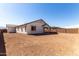 View of the backyard space, showing the home's exterior and patio at 12322 W Marguerite Ave, Avondale, AZ 85323