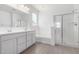Bright main bathroom with double sinks, separate tub, shower, and modern fixtures at 12322 W Marguerite Ave, Avondale, AZ 85323