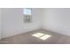 Bright bedroom featuring neutral carpet, a window with a view, and ample natural light at 12322 W Marguerite Ave, Avondale, AZ 85323