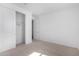 Bedroom boasts neutral carpet, closet with sliding doors, recessed lighting, and access to other rooms at 12322 W Marguerite Ave, Avondale, AZ 85323