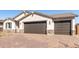 Beautiful home exterior with a paver driveway and two-car garage at 12322 W Marguerite Ave, Avondale, AZ 85323
