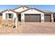 Beautiful single-Gathering home with a two-car garage, desert landscaping, and a paved brick driveway at 12322 W Marguerite Ave, Avondale, AZ 85323