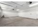 A bright open two-car garage features concrete flooring and white walls at 12322 W Marguerite Ave, Avondale, AZ 85323