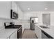 Bright kitchen with stainless steel appliances, white cabinets, and quartz countertops at 12322 W Marguerite Ave, Avondale, AZ 85323