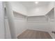 Spacious walk-in closet with ample shelving and carpeted flooring at 12322 W Marguerite Ave, Avondale, AZ 85323