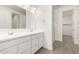 A bright bathroom features double sinks, white cabinets, and a walk-in glass door shower at 12326 W Marguerite Ave, Avondale, AZ 85323