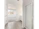 A bathroom features tiled floors, a glass-door shower, and an open view to the carpeted bedroom at 12326 W Marguerite Ave, Avondale, AZ 85323