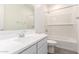 A bright bathroom features tiled floors, a bathtub and shower, and a single sink at 12326 W Marguerite Ave, Avondale, AZ 85323