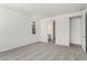 A carpeted bedroom features a window letting in natural light and a doorway to the bathroom at 12326 W Marguerite Ave, Avondale, AZ 85323