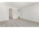 A carpeted bedroom features white walls and doorways to the bathroom and walk-in closet at 12326 W Marguerite Ave, Avondale, AZ 85323