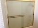 Bathroom shower stall with glass doors and gold trim at 10509 W Tropicana Cir, Sun City, AZ 85351