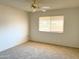 Bedroom with neutral carpet, ceiling fan and a window letting in lots of light at 10509 W Tropicana Cir, Sun City, AZ 85351