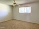 Bedroom featuring a ceiling fan, window, and carpet at 10509 W Tropicana Cir, Sun City, AZ 85351