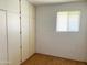 Bedroom with carpet, window and white brick wall and built in cabinets at 10509 W Tropicana Cir, Sun City, AZ 85351