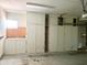 Spacious garage featuring ample storage cabinets and a well-lit interior at 10509 W Tropicana Cir, Sun City, AZ 85351