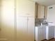 Bright laundry room with washer, dryer and built in cabinets for storage at 10509 W Tropicana Cir, Sun City, AZ 85351