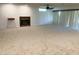 Spacious living room featuring a cozy fireplace, ceiling fan, and sliding glass doors at 10509 W Tropicana Cir, Sun City, AZ 85351