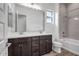 Bathroom with double vanity and gray tile shower at 5535 W St Moritz Ln, Glendale, AZ 85306