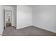 Simple bedroom with gray carpet and access to bathroom at 5535 W St Moritz Ln, Glendale, AZ 85306