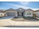 Gray exterior boasts a two-car garage and nicely landscaped front yard at 5535 W St Moritz Ln, Glendale, AZ 85306