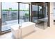 Bright bathroom features a freestanding tub, large windows, and sleek, modern fixtures at 6850 E Joshua Tree Ln, Paradise Valley, AZ 85253