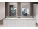 Elegant bathroom with dual sinks, marble countertop, and stylish lighting at 6850 E Joshua Tree Ln, Paradise Valley, AZ 85253