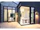 Modern dining area with glass doors, sleek lighting, and stylish decor at 6850 E Joshua Tree Ln, Paradise Valley, AZ 85253