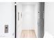 Modern residential elevator with white interior and wood flooring for easy access at 6850 E Joshua Tree Ln, Paradise Valley, AZ 85253