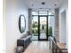 Elegant foyer with stone accent wall, modern light fixture, and stylish decor at 6850 E Joshua Tree Ln, Paradise Valley, AZ 85253