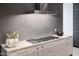 Modern kitchen with grey backsplash, marble countertop, and stainless steel appliances at 6850 E Joshua Tree Ln, Paradise Valley, AZ 85253