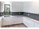 Stylish kitchen with white cabinets, granite countertops, and stainless steel sink at 6850 E Joshua Tree Ln, Paradise Valley, AZ 85253