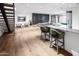 Open concept lower level with bar, stairs, and living area create a modern aesthetic at 6850 E Joshua Tree Ln, Paradise Valley, AZ 85253