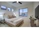 This bedroom boasts neutral tones, bright natural light, and is adorned with modern décor and stylish furniture at 11566 E Christmas Cholla Dr, Scottsdale, AZ 85255